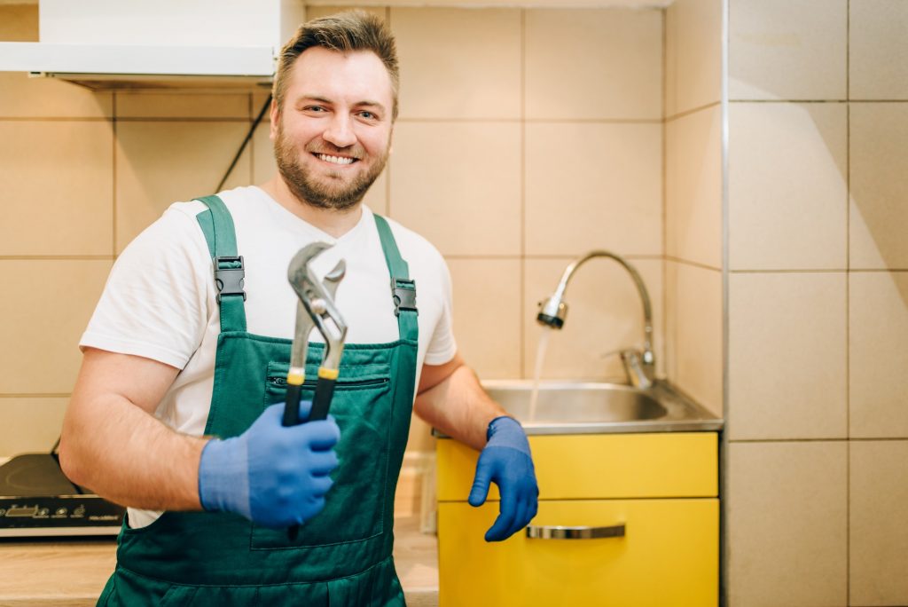 plumber-in-uniform-holds-wrench-handyman